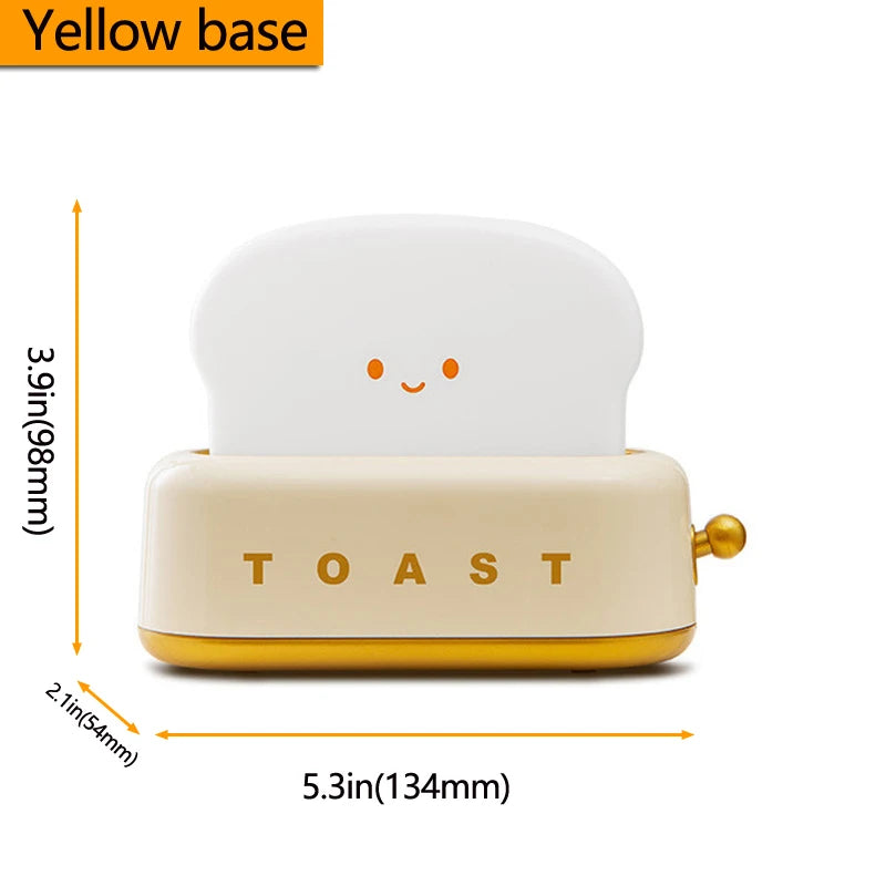 Small toaster night light bed lamp with a cartoonish design on a white background, showing measurements.