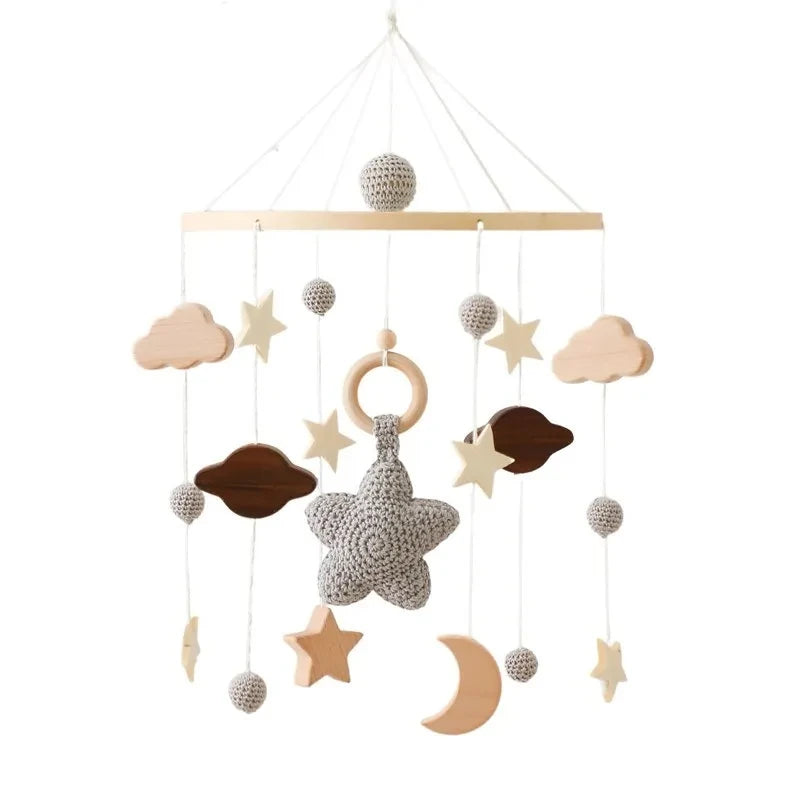 Wooden Baby mobile with stars, clouds, and moons on a white background