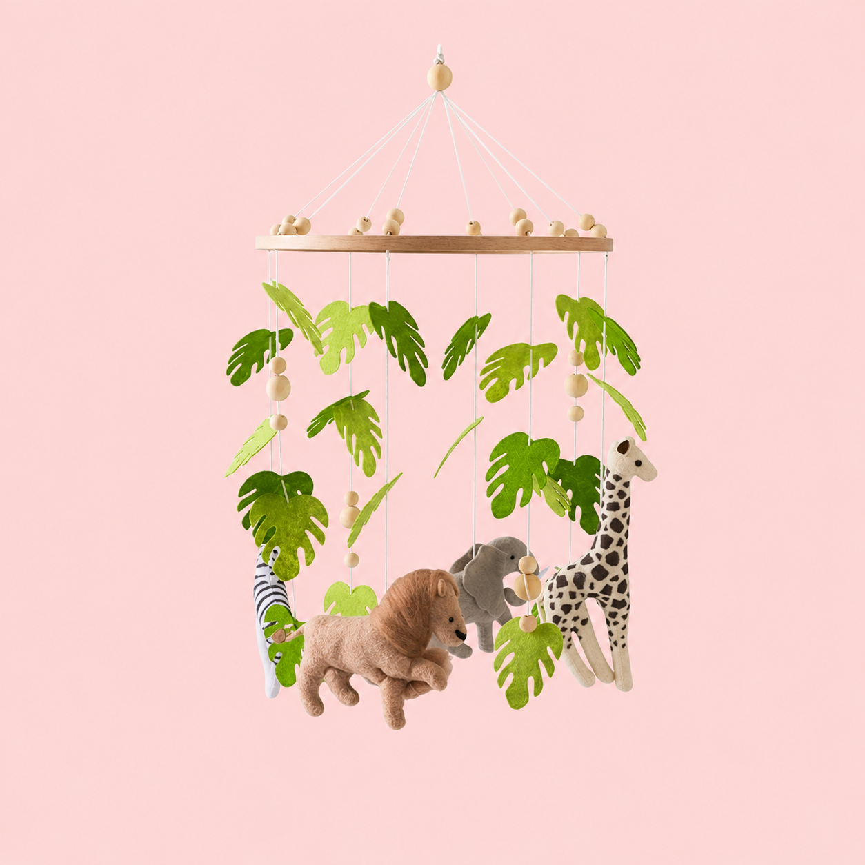 Children's mobile with plush jungle animals lion, zebra, elephant, giraffe and leaf patterns on a pink background