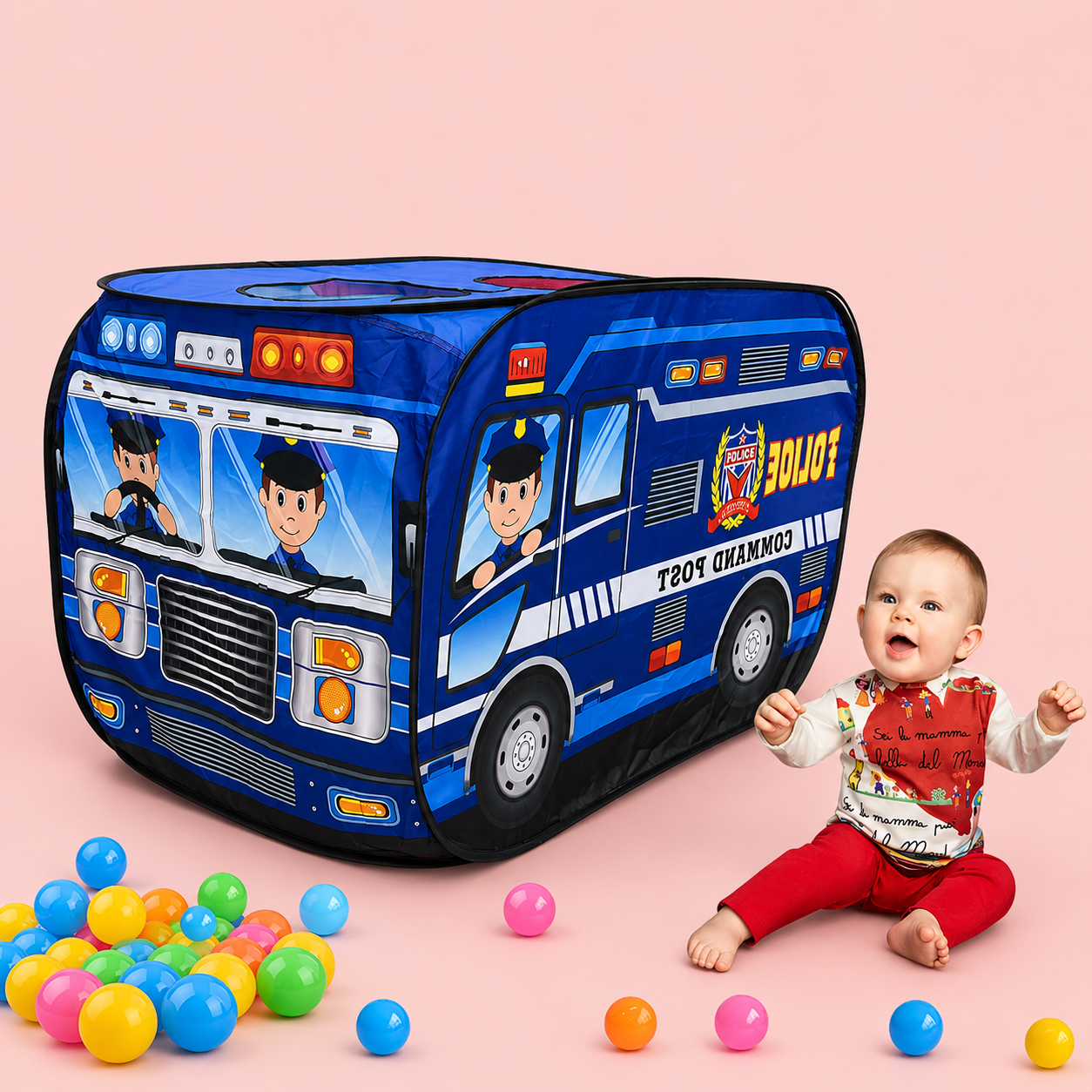 Child playing with a police car-shaped play tent and colorful balls on a pink background
