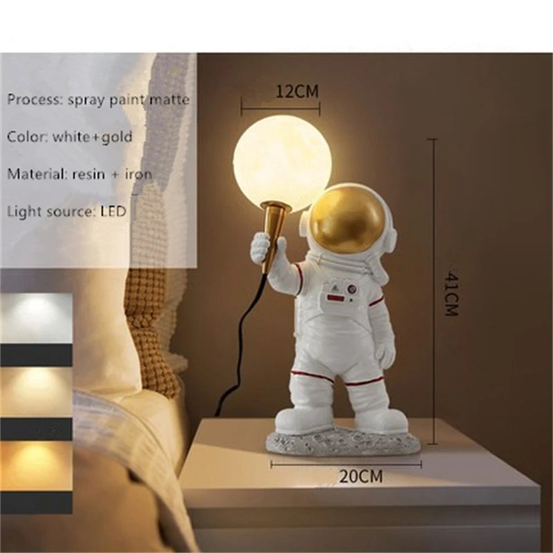 Astronaut lamp with a moon shaped light bulb held in one hand on a wooden surface, with dimensions displayed.