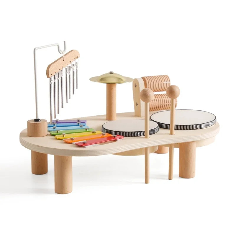 Wooden musical toy set with various instruments on a white background