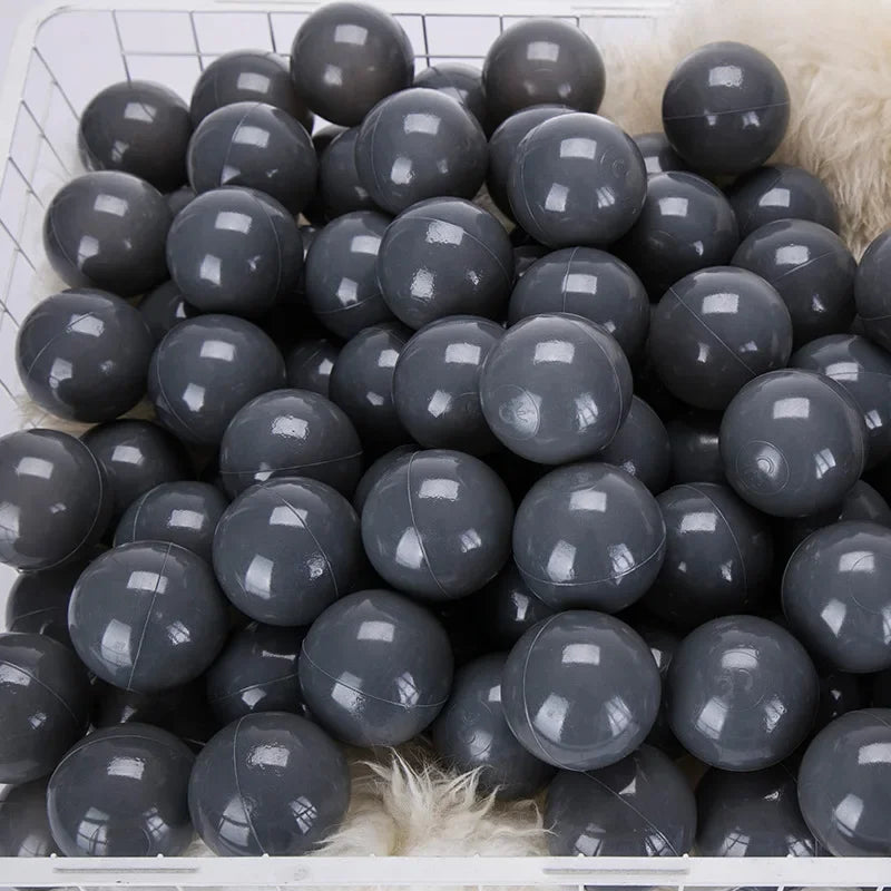 Basket filled with gray balls for tent ball pitt