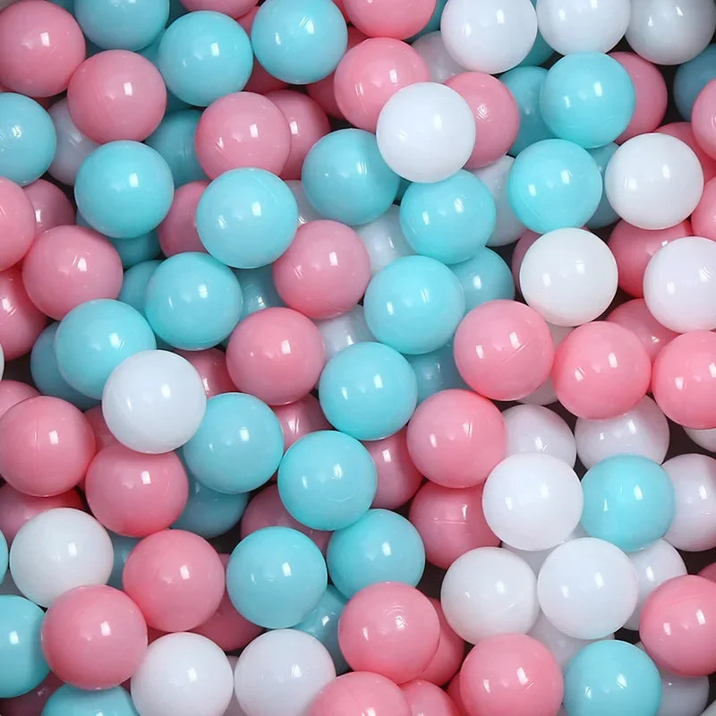 Colorful ball pit with pink, blue, and white balls.