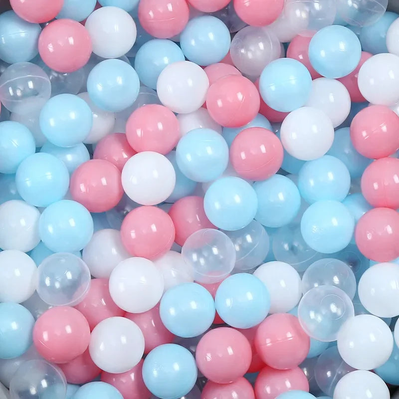 Colorful plastic balls in pink, blue, and white