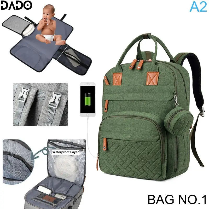 Green diaper bag with multiple compartments and features, including a baby changing mat and waterproof layer.