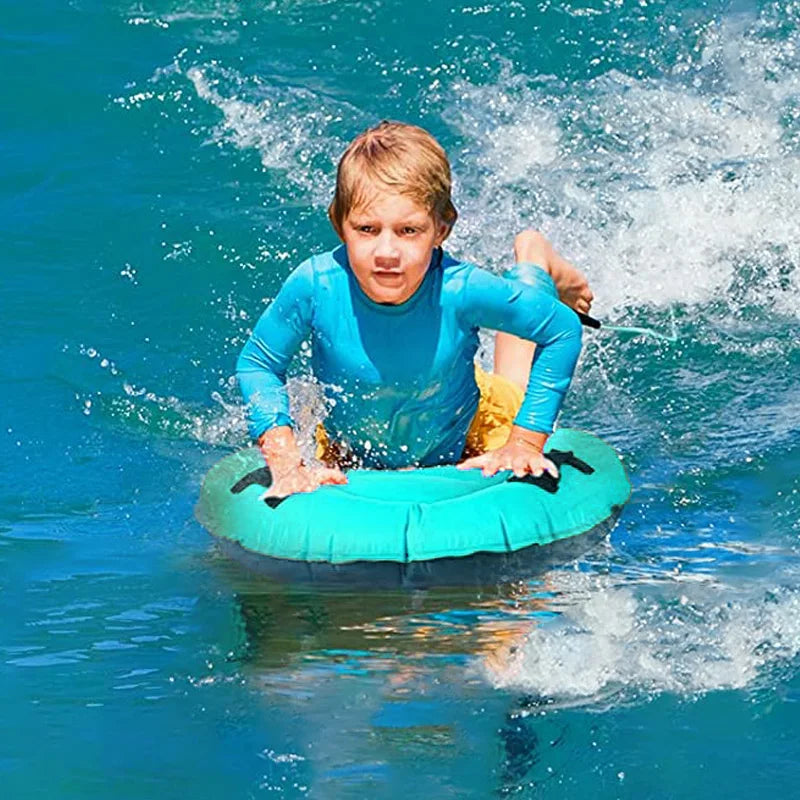 Child on a teal inner bodyboard tube in the ocean