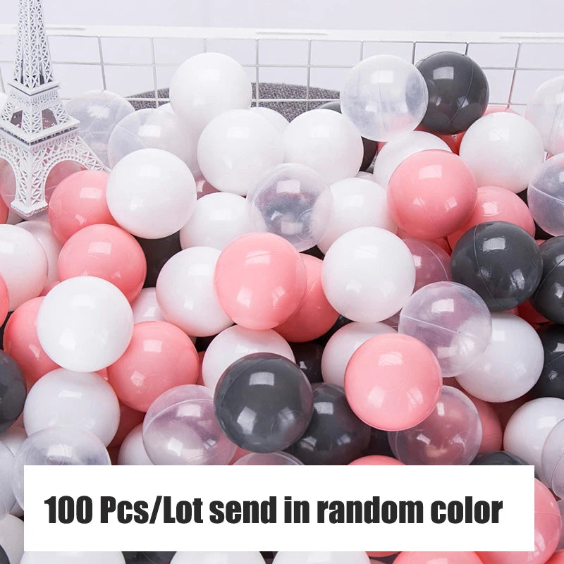 Colorful plastic balls in pink, white, and grey.