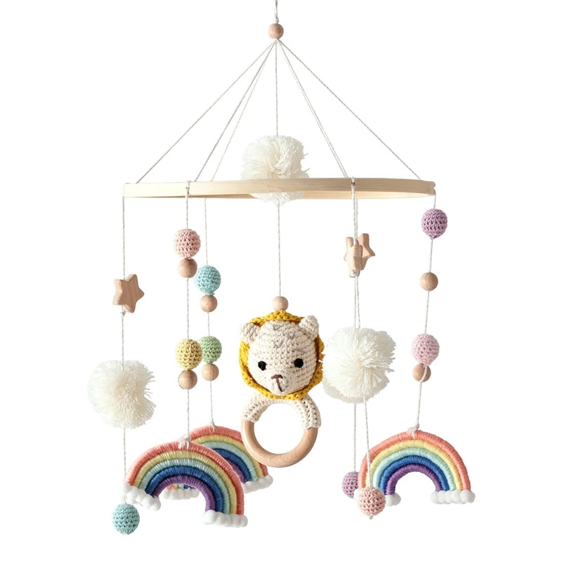 Children's crib mobile with lion face, rainbow, and colorful beads on a white background
