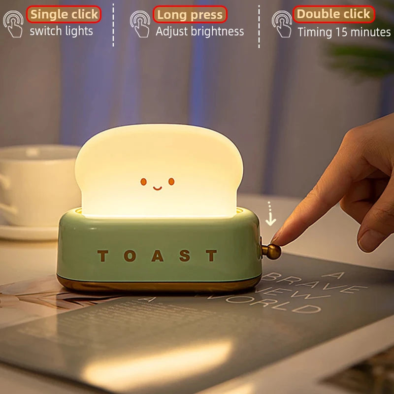 Toast-shaped night light with a hand interacting with it on a table.