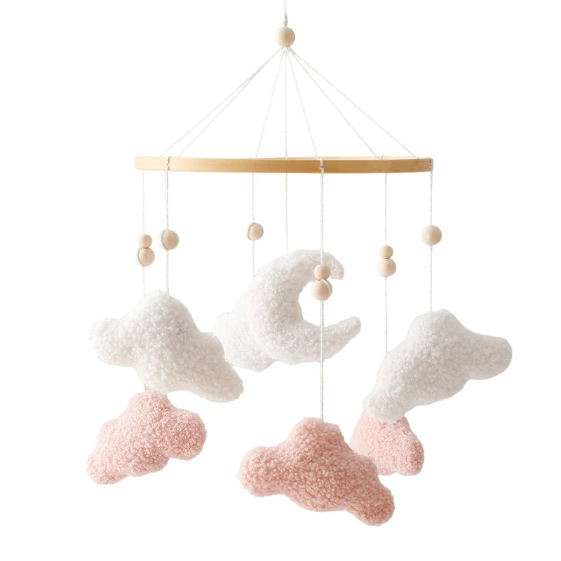 Baby crib mobile with cloud and moon shapes on a white background