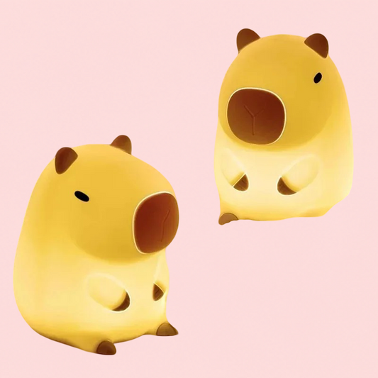 Two yellow cartoon-style Cute Capybara lamps shaped like animals on a pink background