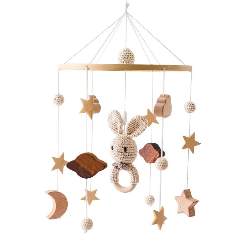 wood and felt Baby mobile with rabbit toy, stars, and wooden elements.