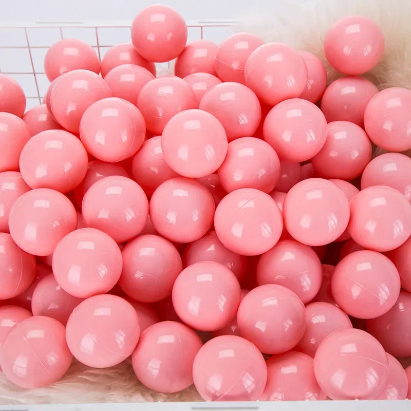 Pink plastic balls on a white tiled floor