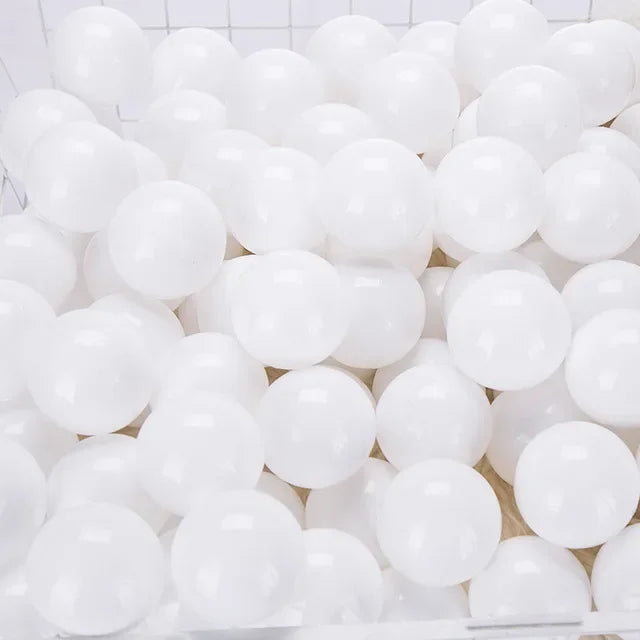Close-up of a pile of white balls on a tiled floor