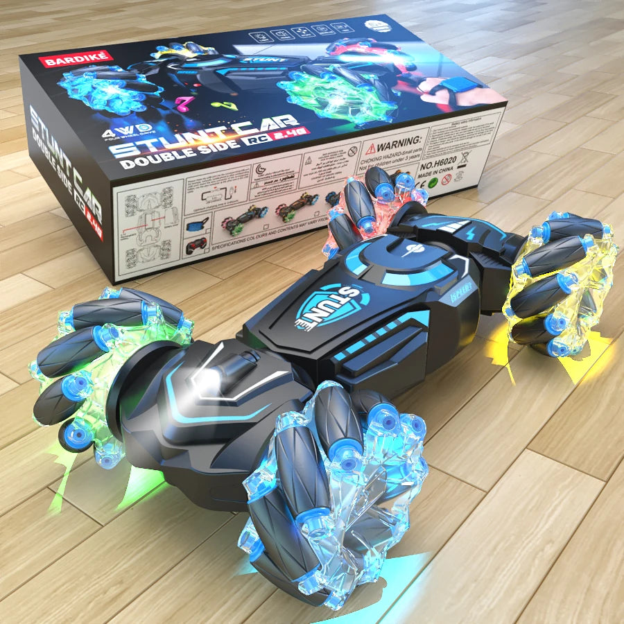 Toy car with LED lights on a wooden floor next to its packaging box.