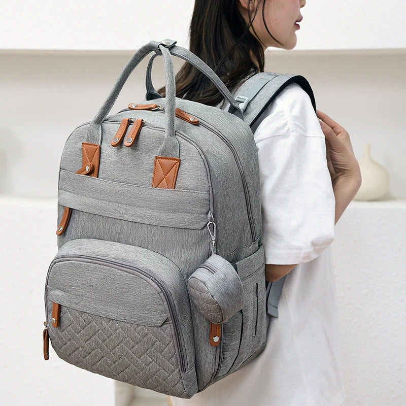 Person wearing a gray backpack with brown accents
