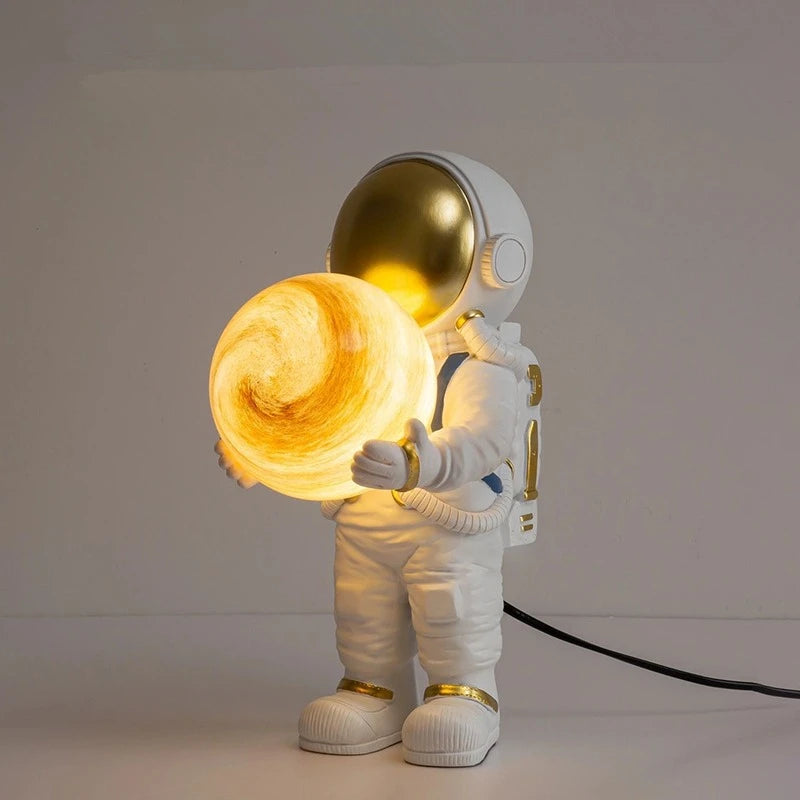Astronaut night light lamp holding a glowing sphere on a plain background