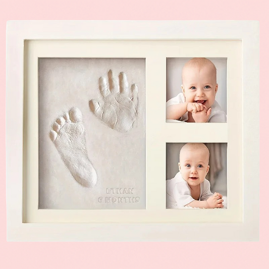 Baby hand and foot print frame with photos of a baby on a pink background