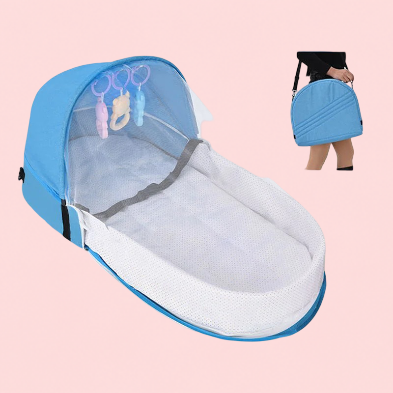 Portable baby crib with mesh top and blue border on a pink background
