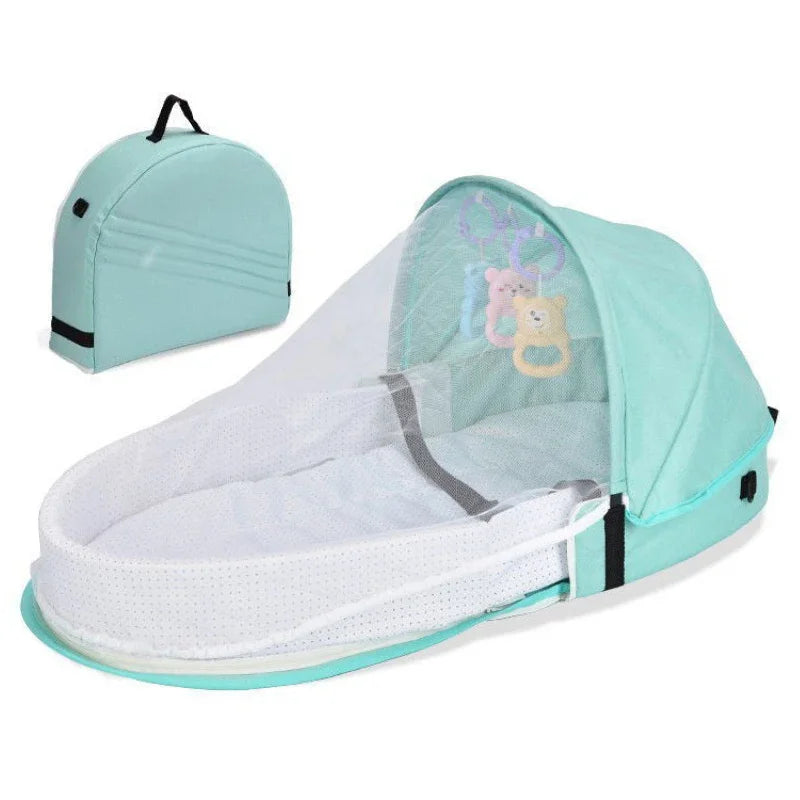 Mint green baby bassinet with canopy and matching bag on a white background