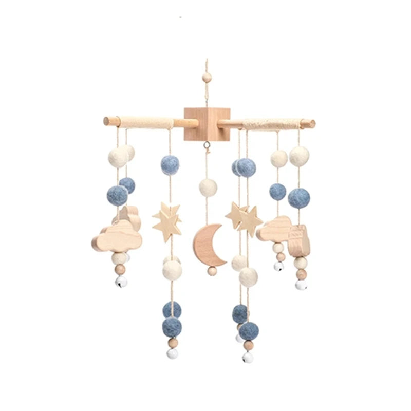 Wooden and felt baby crib mobile with stars, moons, and colorful beads.