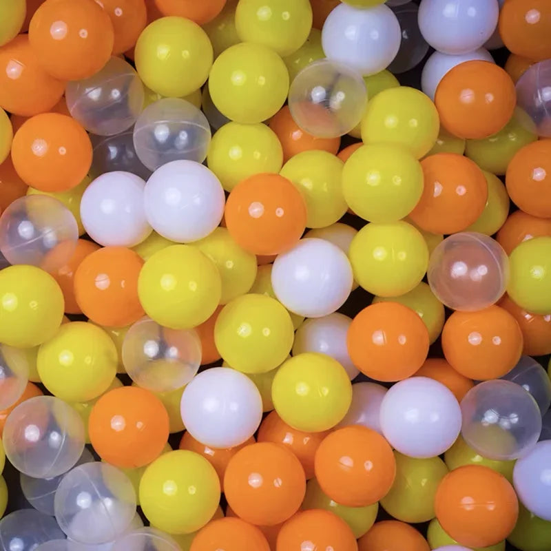 Close-up of colorful plastic balls including orange, yellow, and white.