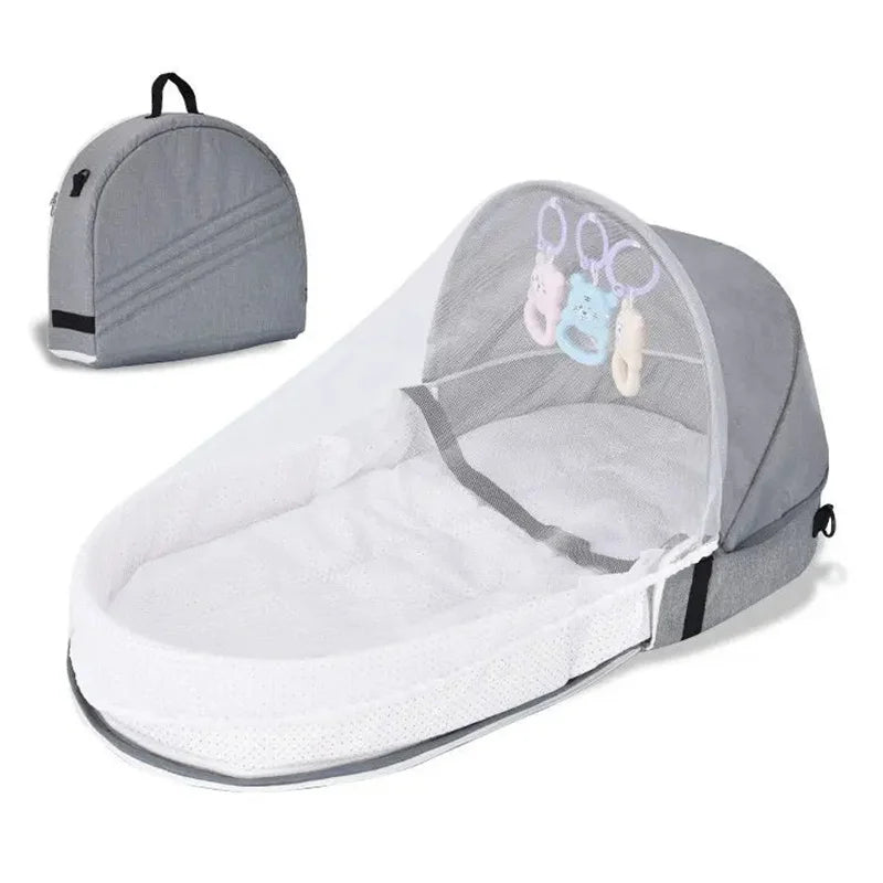 Grey Baby bassinet with mosquito net and travel bag on a white background