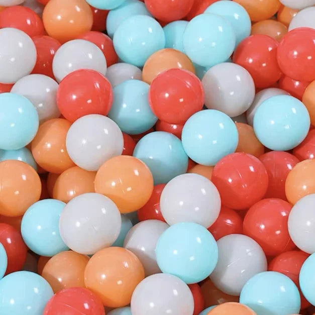 Colorful plastic balls including red, blue, orange, and white in a pile for tent ball pitt