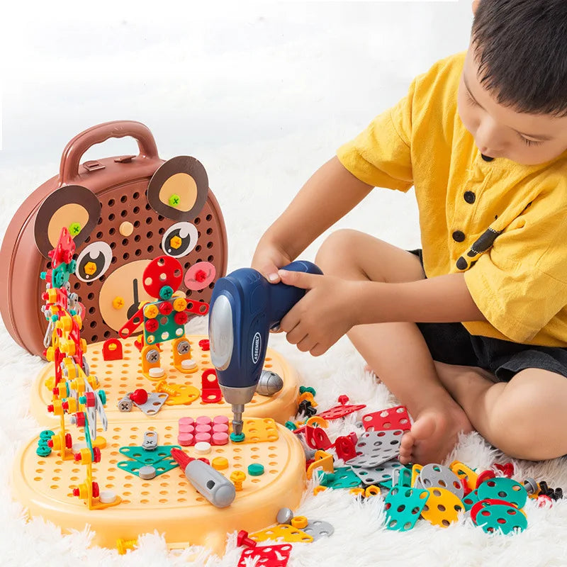 Child playing with a colorful toy workshop set on a white surface