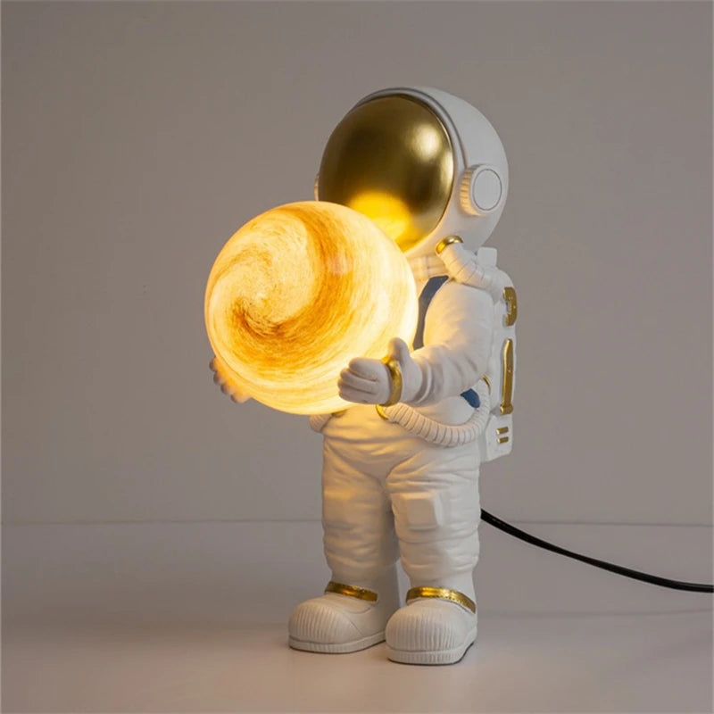 Spaceman lamp holding a glowing planet on a plain background