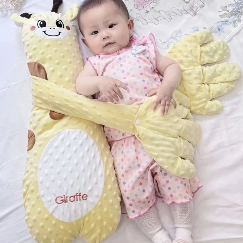 Baby lying on a yellow giraffe-shaped pillow with cartoon face