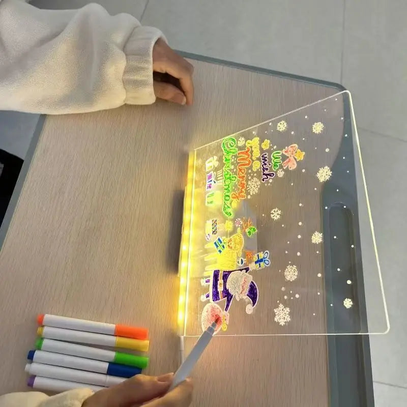Person using a light-up board with colorful markers on a wooden table.
