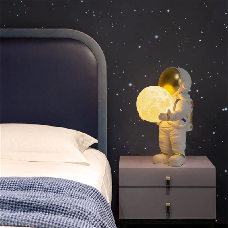 Spaceman night light on a bedside table with a bed and starry wall in the background
