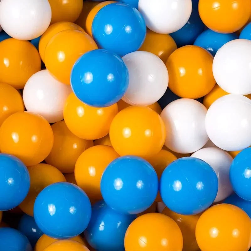 Colorful plastic balls including blue, orange, and white in a pile for a tent ball pitt