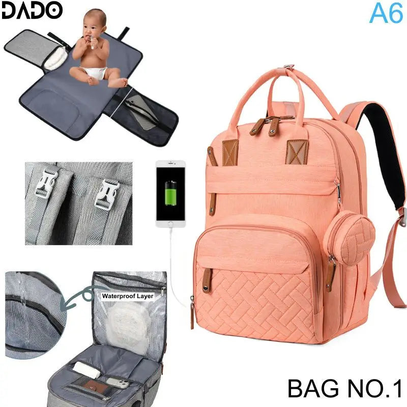 Pink backpack with baby changing pad and multiple features on a white background