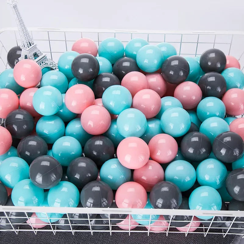 Basket filled with colorful plastic balls including pink, blue, and gray ones for tent ball pitt