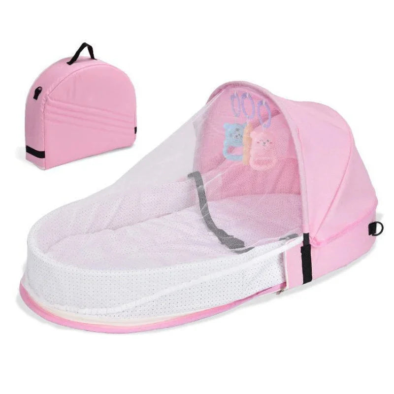 Pink baby bassinet with matching travel bag on a white background