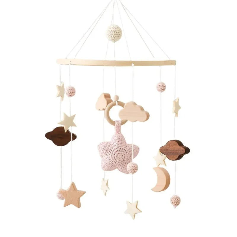 felt and wood Baby crib mobile with stars, clouds, and other shapes.