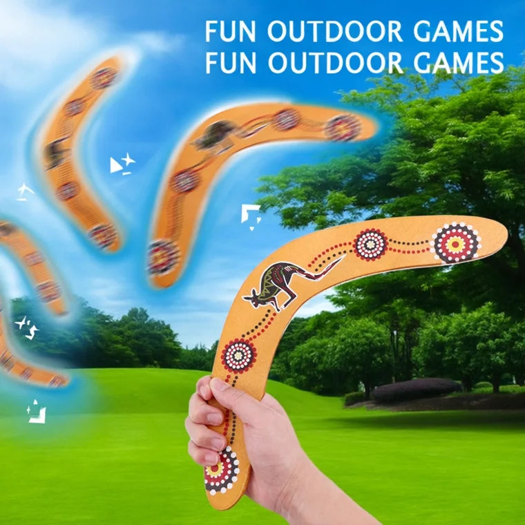 Decorative boomerang with Aboriginal art design held by a hand.