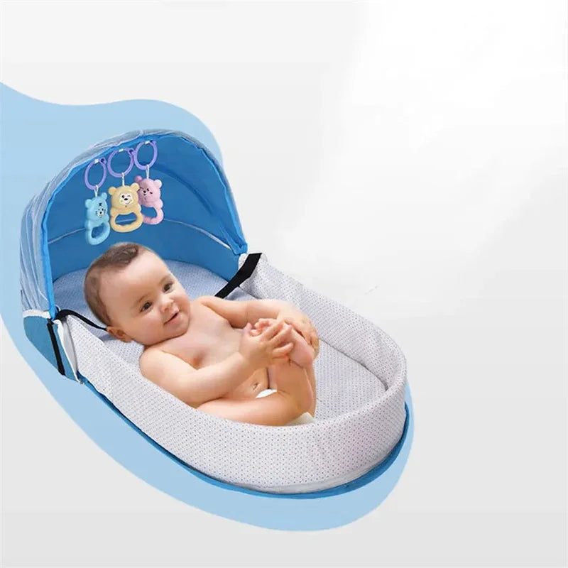 Baby lying in a blue and white baby bouncer with colorful hanging toys on a light gray background