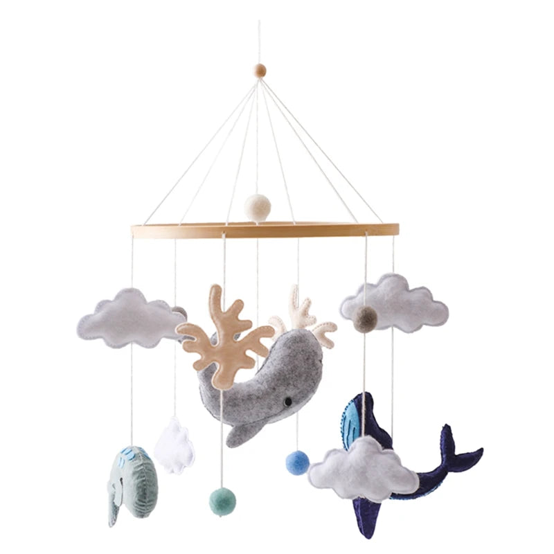 Baby crib mobile with whale, fish, and cloud designs on a white background