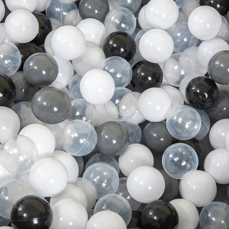 Close-up of a pile of black, white, and gray balls.