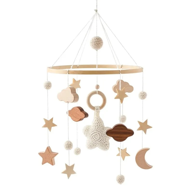 Wooden and felt baby crib mobile with stars, moons, clouds and planets.