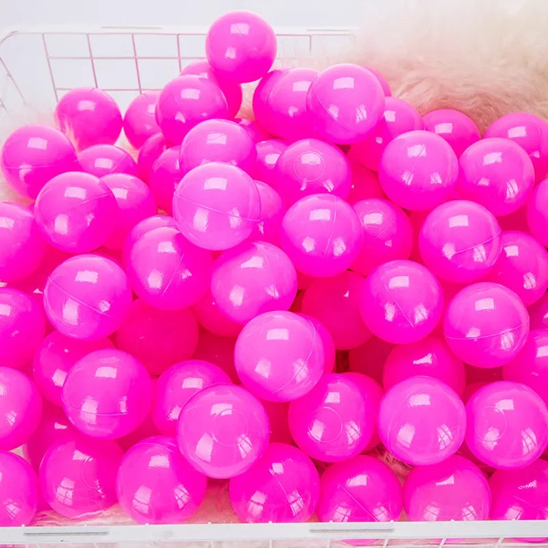 Basket filled with pink plastic balls on a tent ball pitt